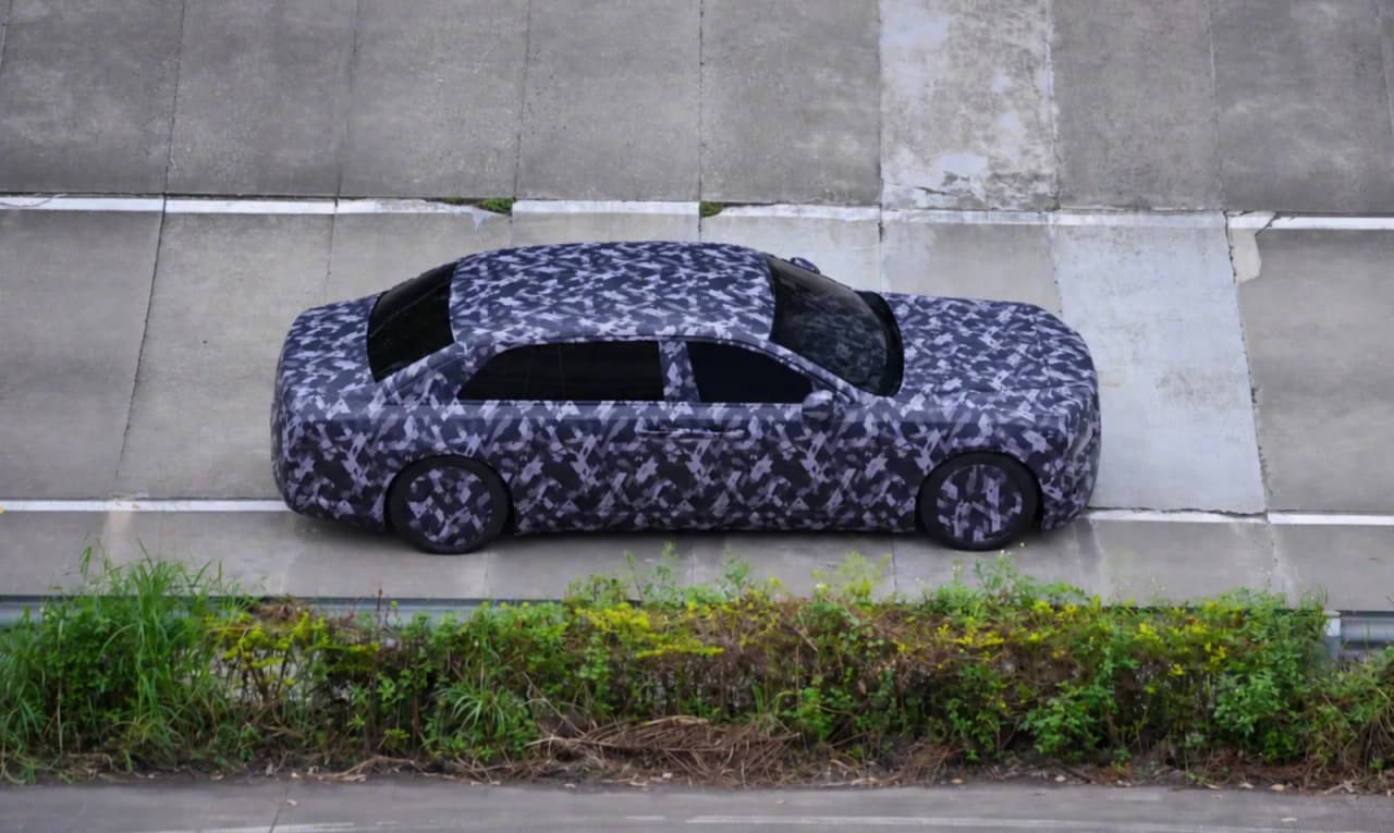 Camouflaged long-wheelbase luxury sedan under testing