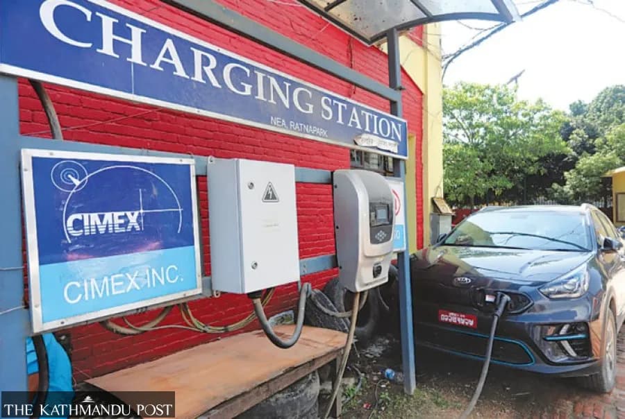 An electric vehicle charging at a charging station.