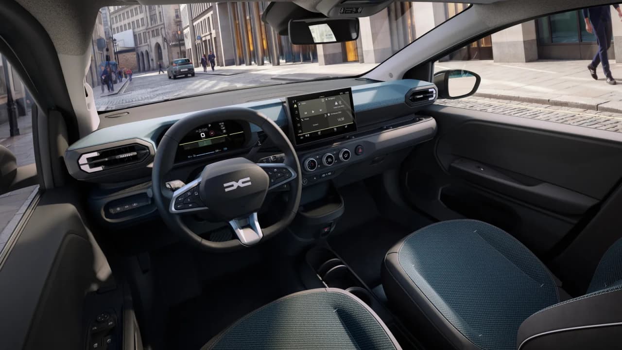 Interior view of the second-generation Dacia Spring EV showing the dashboard, touchscreen, and seats.