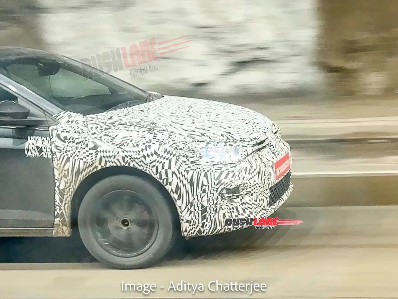 A camouflaged Volkswagen Virtus sedan undergoing testing.