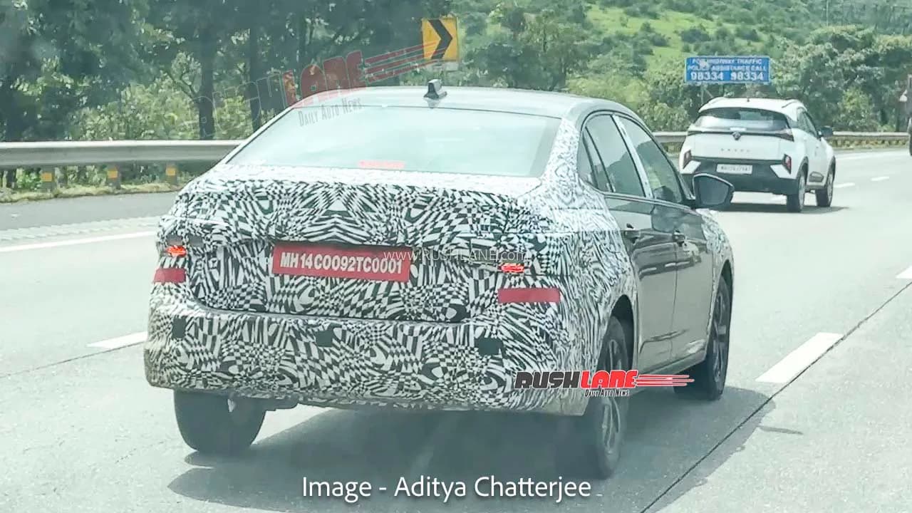 Camouflaged Volkswagen Virtus sedan testing on a highway.