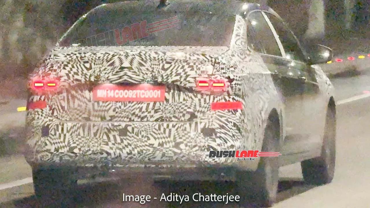 Camouflaged Volkswagen Virtus sedan undergoing testing on a highway.