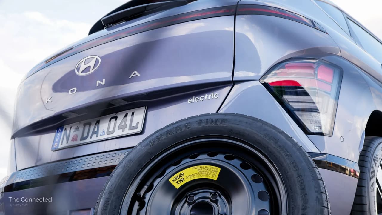 Rear view of a Hyundai Kona Electric showing a spare tire mounted on the vehicle.